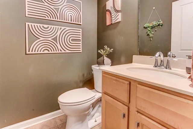 a bathroom with a sink a toilet and a mirror