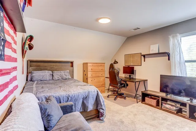 a bedroom with furniture and a window