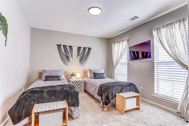 a bedroom with furniture and a window