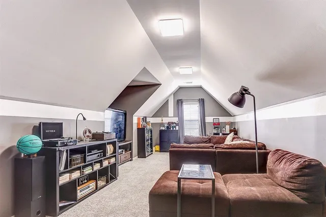 a living room with furniture a ceiling fan and a rug