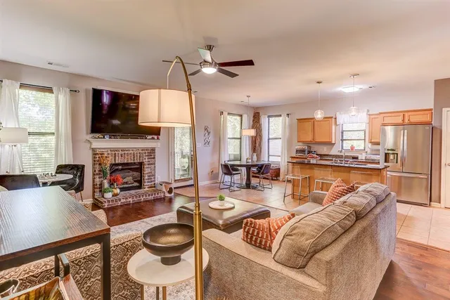 a living room with fireplace furniture and a flat screen tv