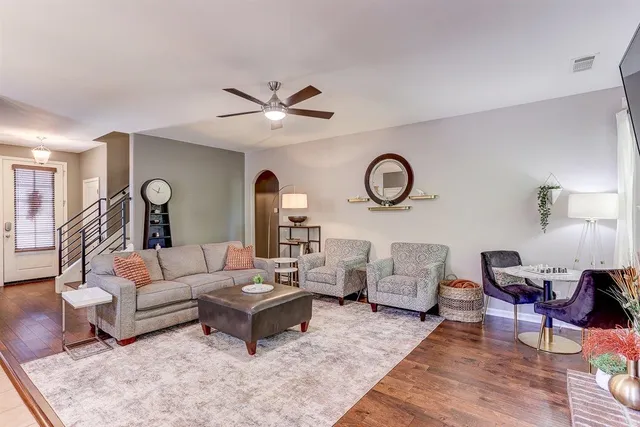 a living room with furniture and wooden floor