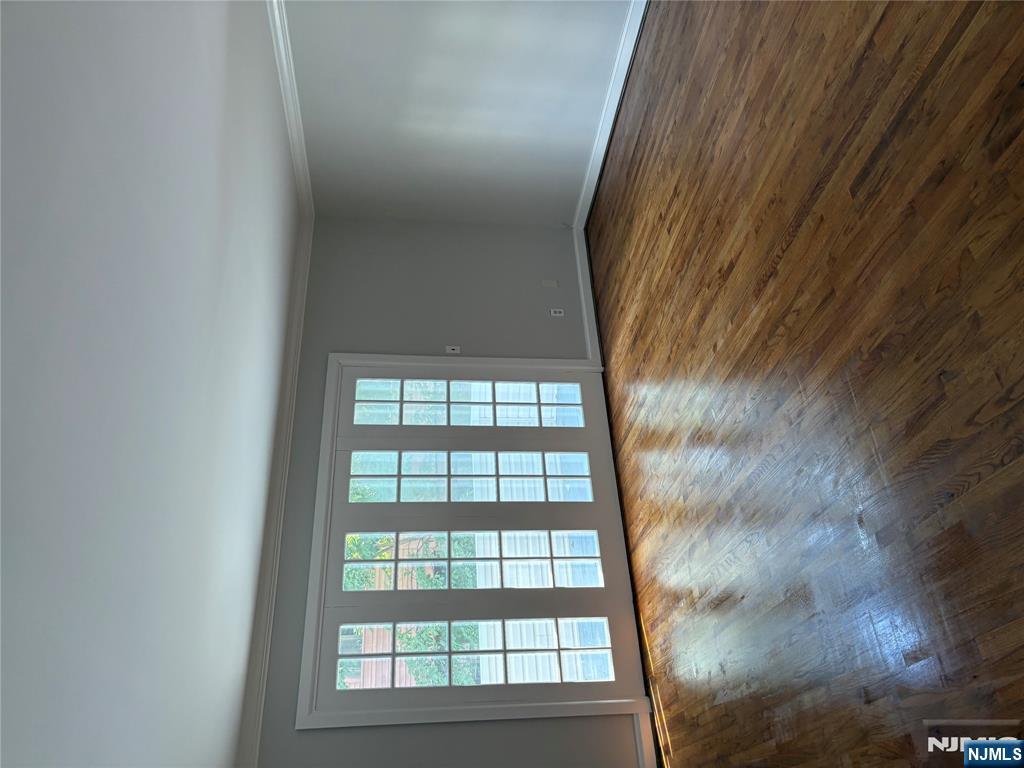 233 Myrtle Avenue, Unit A Fort Lee, NJ 07024 - Photo 2 of 11 a view of an empty room with wooden floor and a window