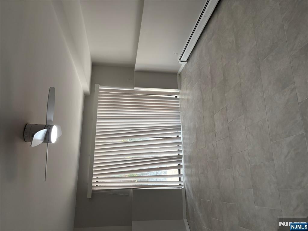 233 Myrtle Avenue, Unit A Fort Lee, NJ 07024 - Photo 8 of 11 a view of an empty room with a window