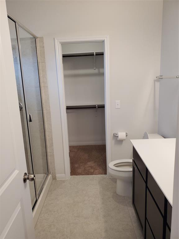 6404 Gunflint Drive Austin, TX 78747 - Photo 15 of 21 A well-appointed primary bathroom featuring a spacious shower and direct access to a walk-in closet.