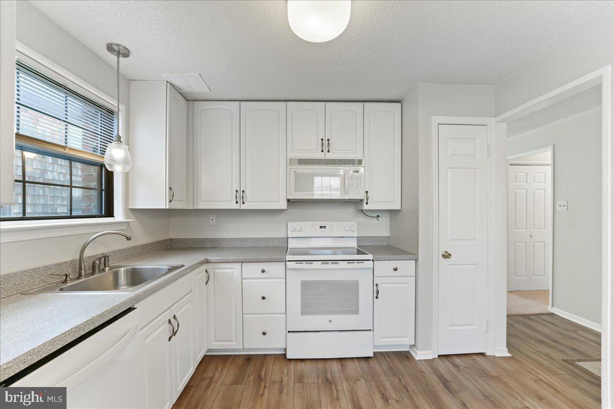 44 Witherspoon Court, Unit 137 Chesterbrook, PA 19087 - Photo 5 of 26 a kitchen with cabinets appliances a sink and a window