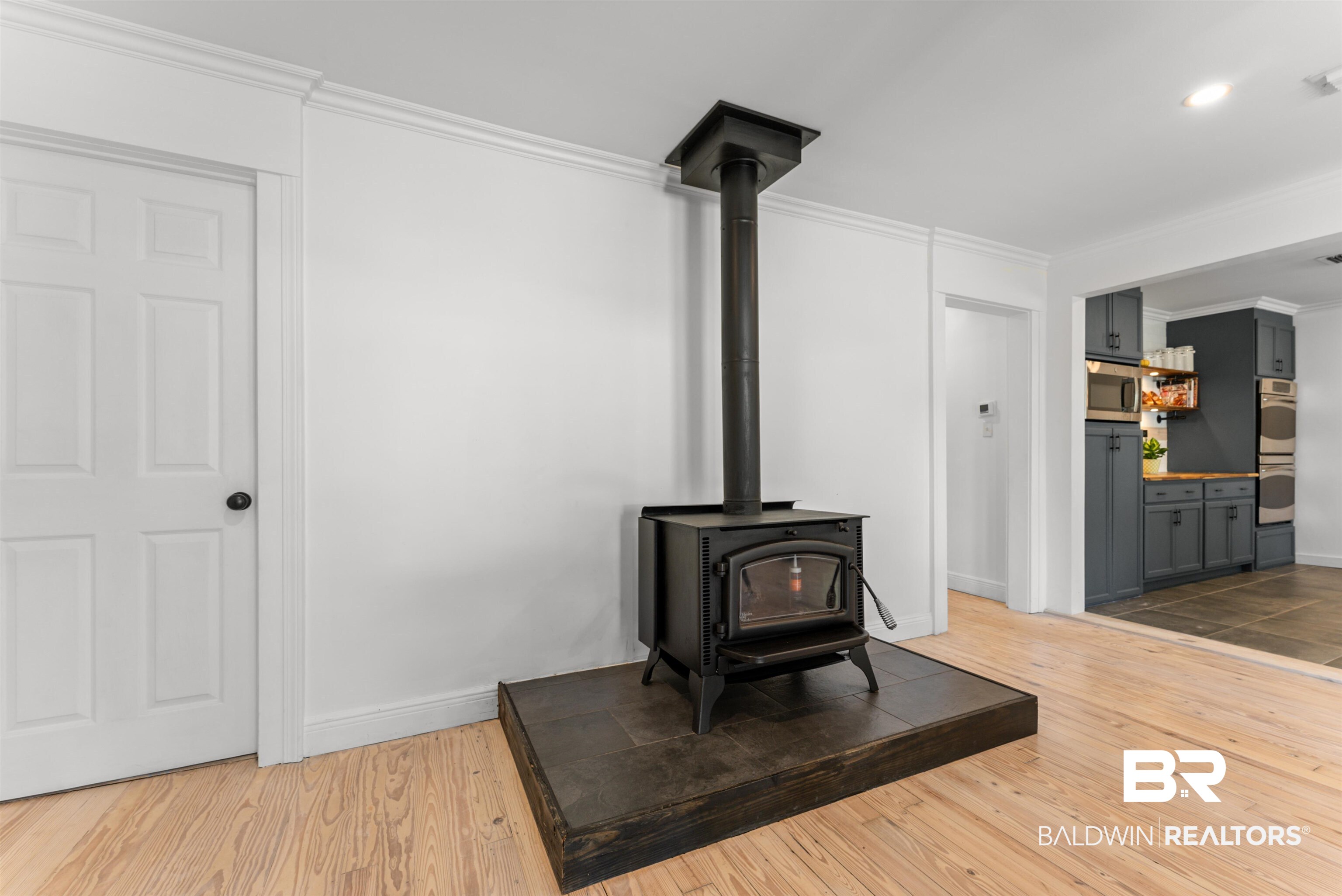 6447 Bemis Lane Bon Secour, AL 36511 - Photo 26 of 62 Freestanding wood stove with a dark tile hearth