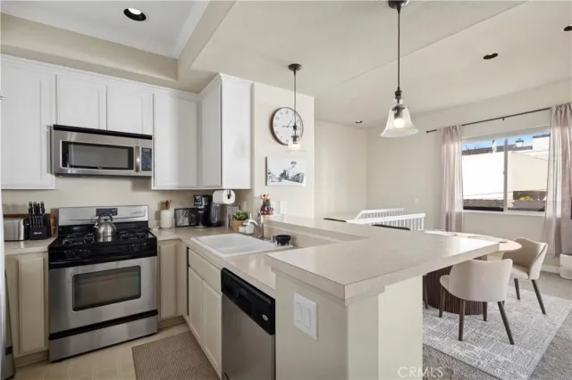 a kitchen with a stove a sink and a refrigerator