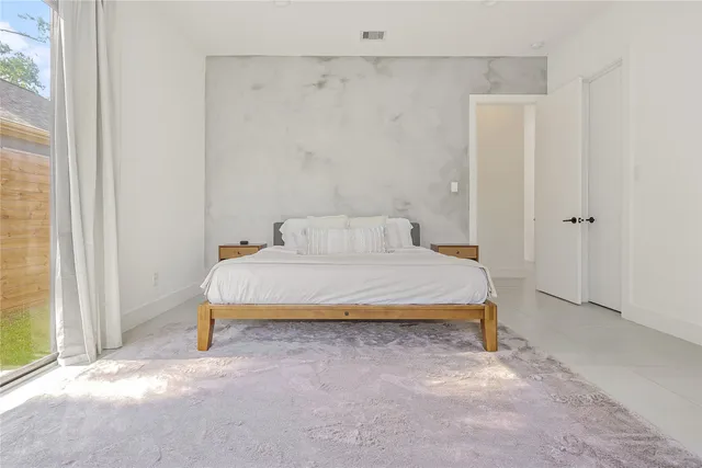 a bathroom with a sink and mirror with window