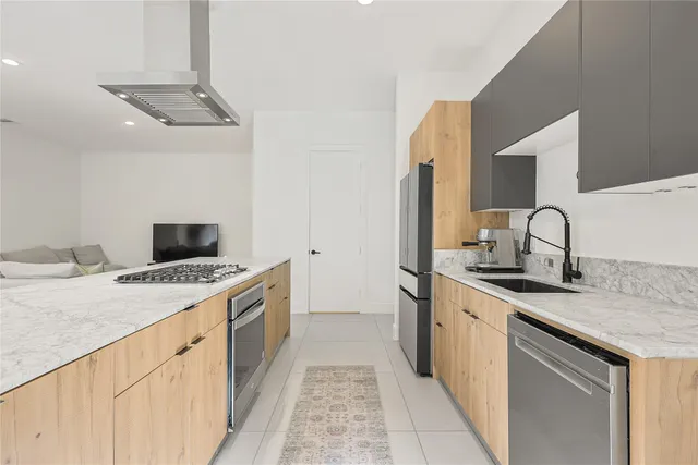 a kitchen with a stove a sink and a refrigerator