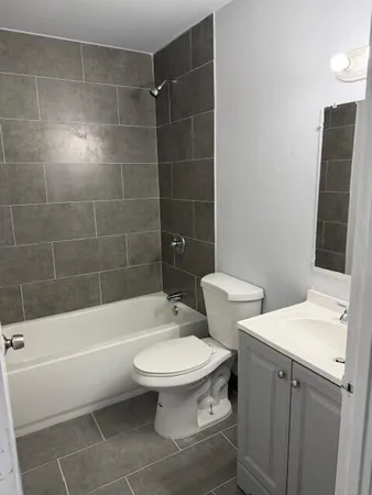 a bathroom with a toilet a sink and bathtub