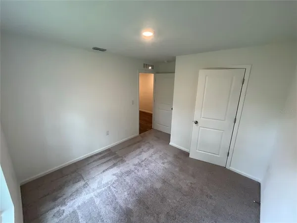 a view of an empty room and a window