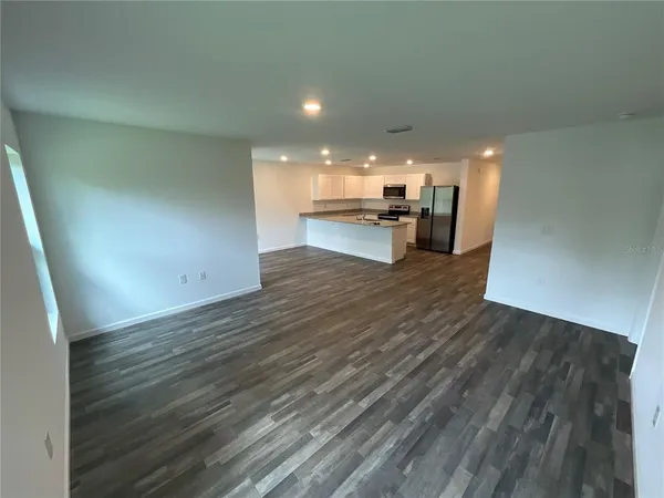 a view of a kitchen with wooden floor