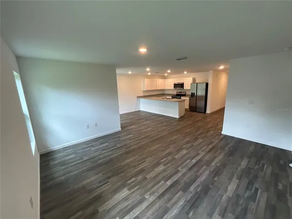 a view of a kitchen with wooden floor