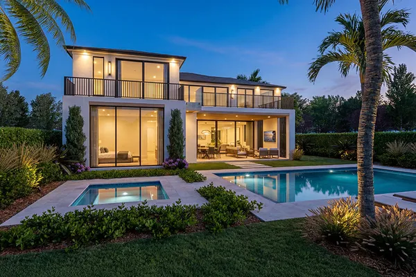 a view of a house with swimming pool and garden