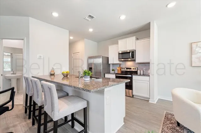 a kitchen with a sink stainless steel appliances and cabinets