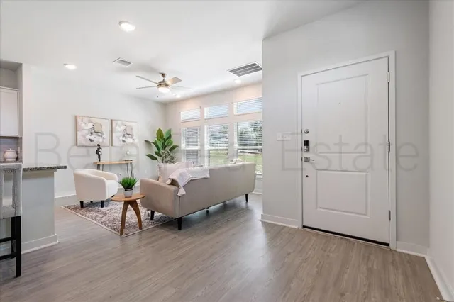 a living room with furniture and wooden floor