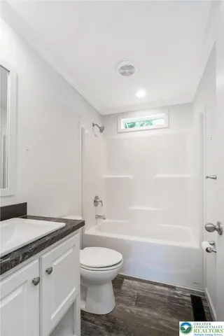 a bathroom with a toilet a sink and bathtub