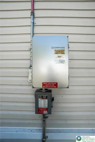 a backyard of a house with plants and wooden fence