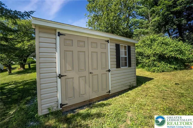 a view of backyard with a garden and deck