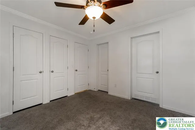 a view of ceiling fan and window in room