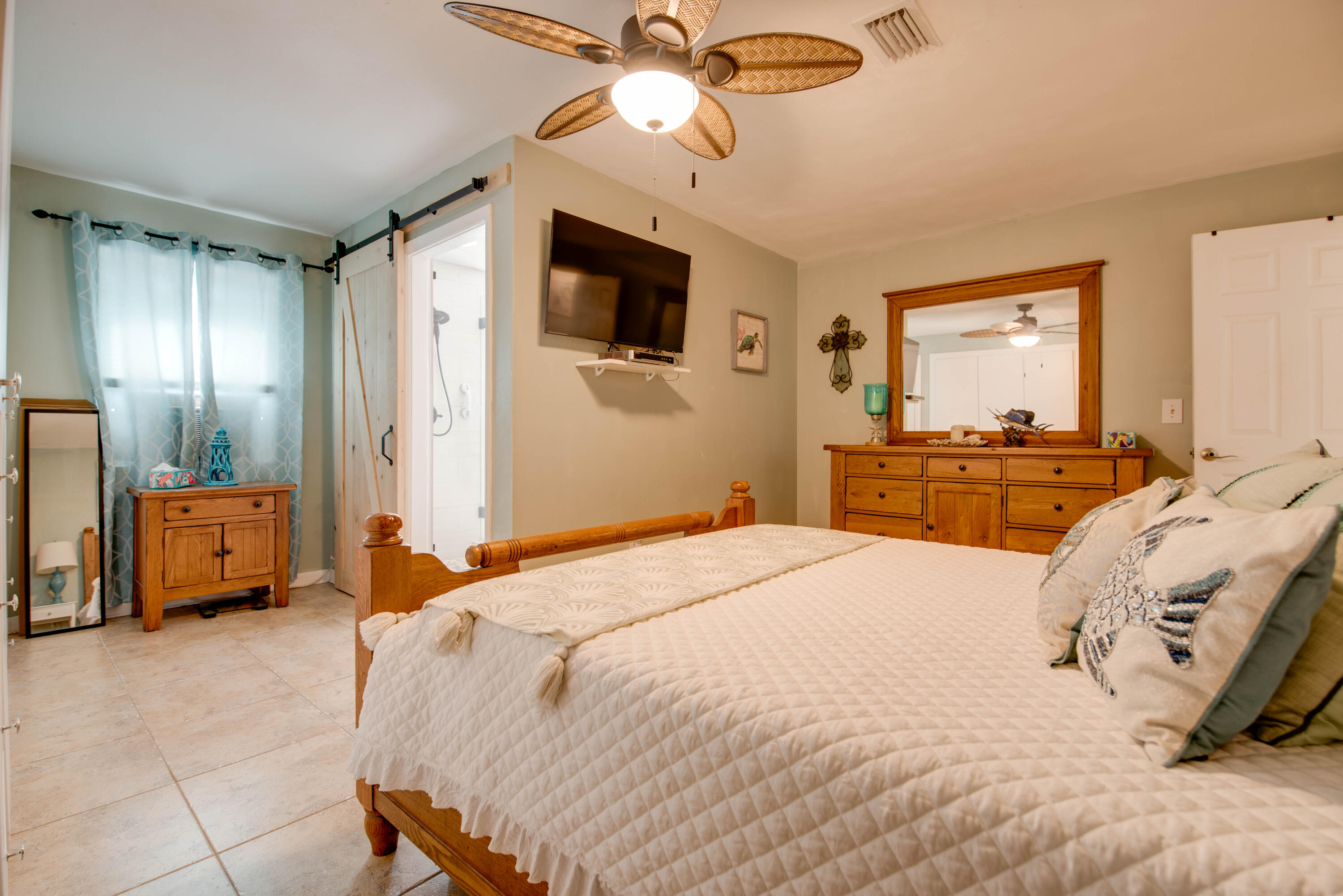 29013 Marigold Drive Big Pine Key, FL 33043 - Photo 11 of 52 a bedroom with a bed and a chandelier