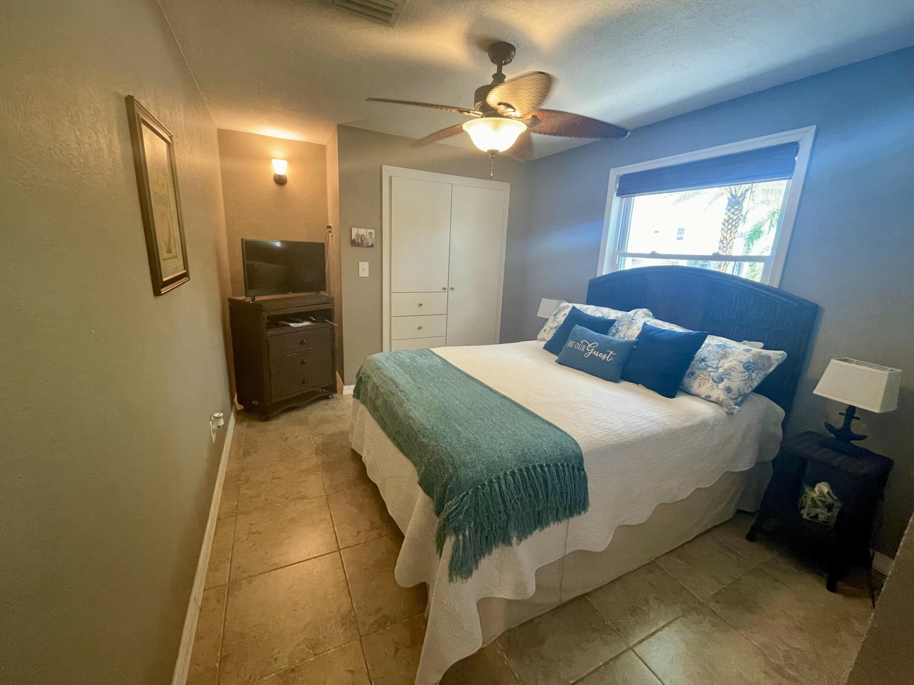 29013 Marigold Drive Big Pine Key, FL 33043 - Photo 13 of 52 a bedroom with a bed and a chandelier