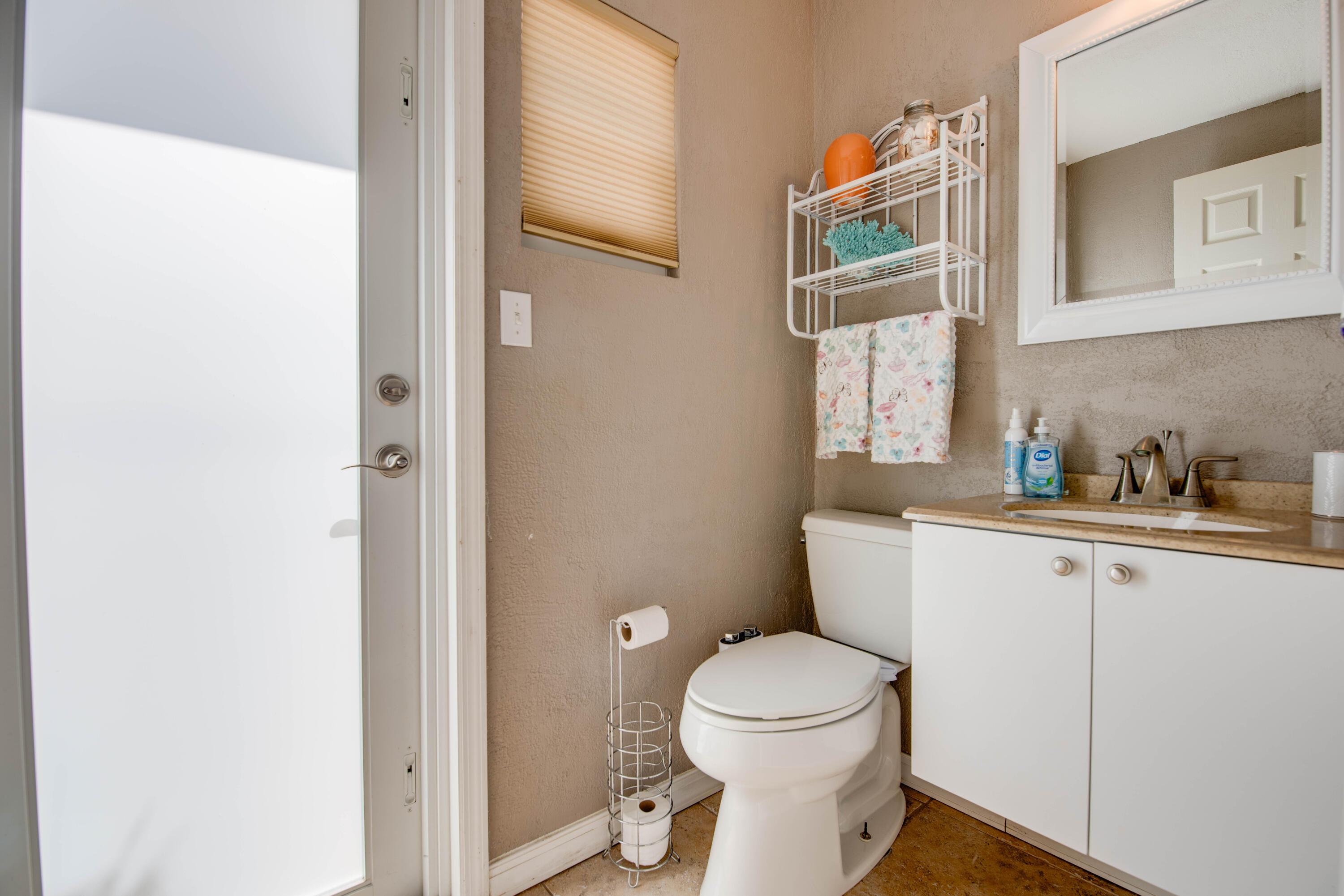 29013 Marigold Drive Big Pine Key, FL 33043 - Photo 19 of 52 a bathroom with a toilet a sink and a mirror