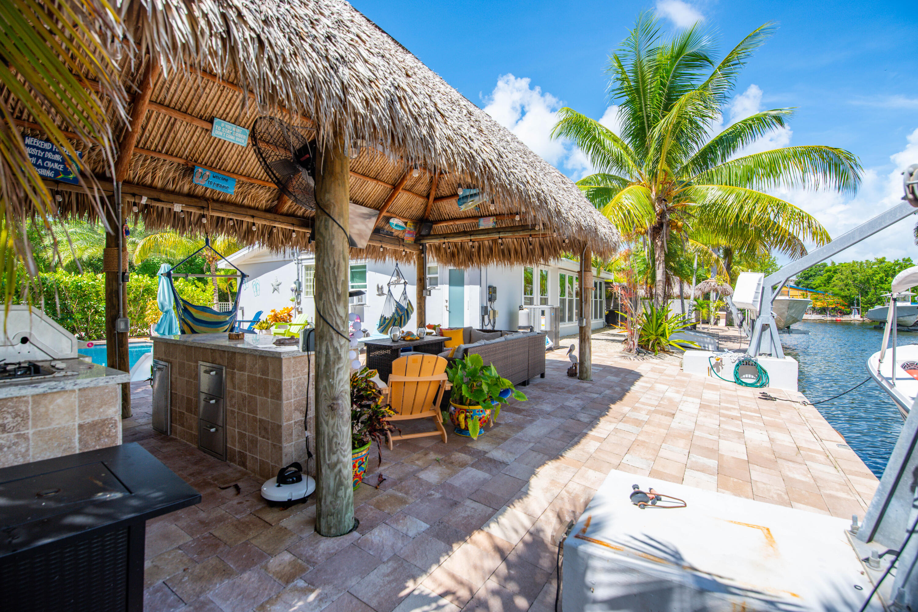 29013 Marigold Drive Big Pine Key, FL 33043 - Photo 30 of 52 a view of a patio with table and chairs potted plants and palm trees