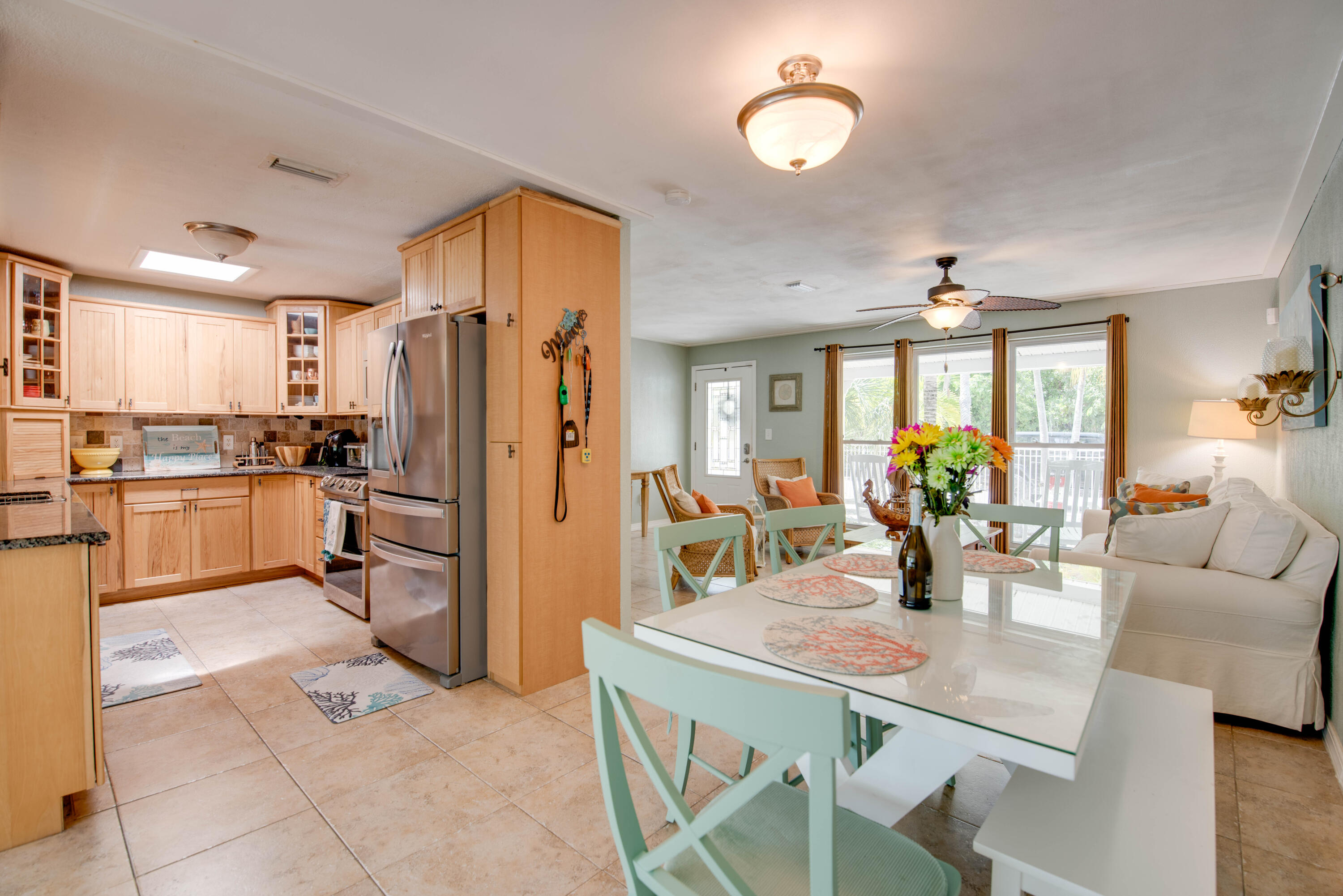 29013 Marigold Drive Big Pine Key, FL 33043 - Photo 4 of 52 a kitchen with stainless steel appliances granite countertop a refrigerator a stove a dining table and chairs