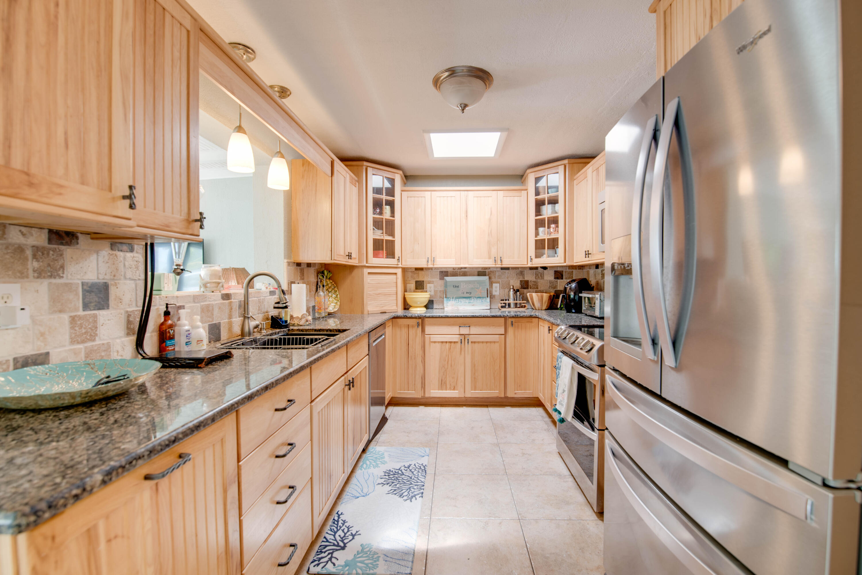 29013 Marigold Drive Big Pine Key, FL 33043 - Photo 6 of 52 a kitchen with stainless steel appliances granite countertop a refrigerator sink and cabinets