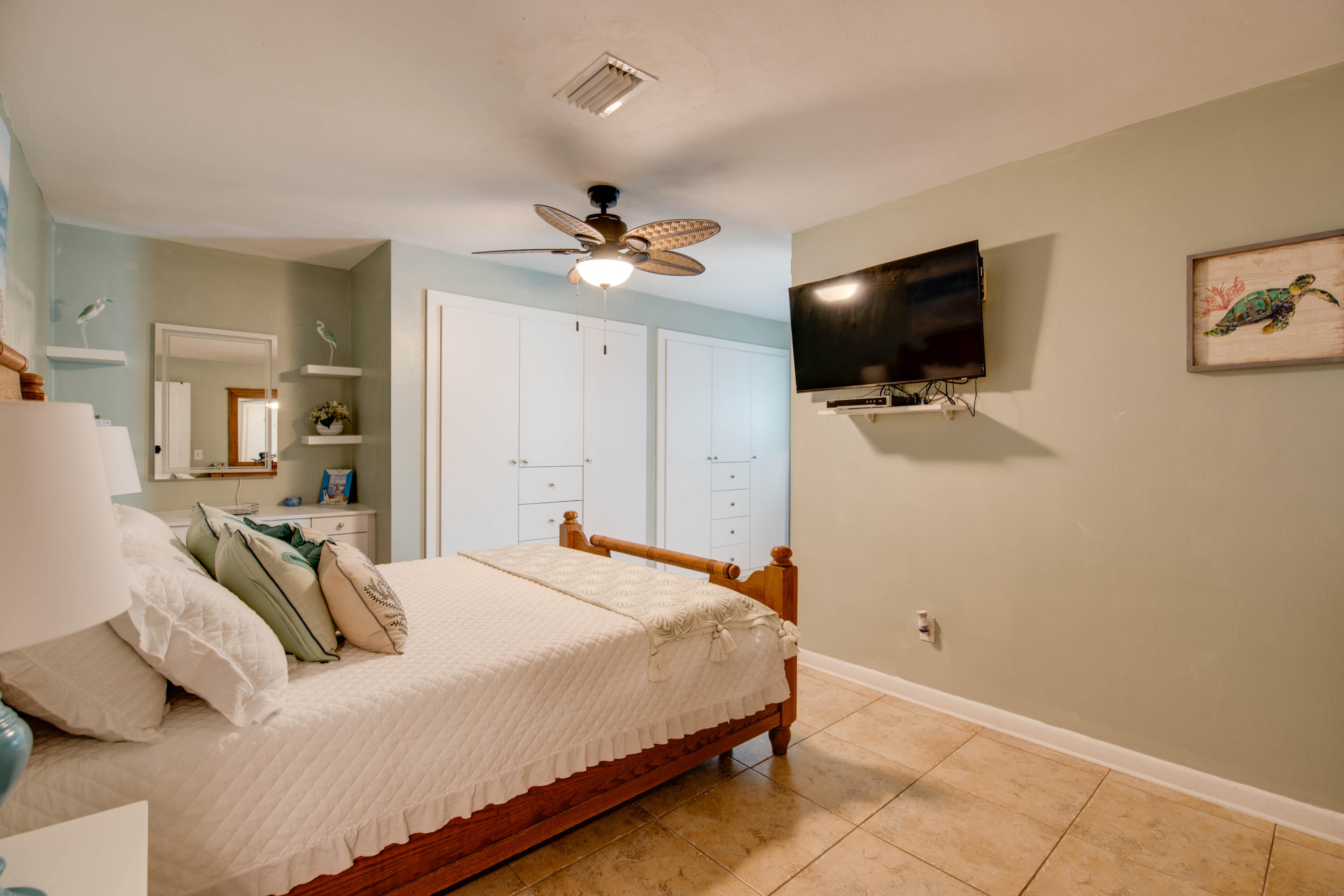 29013 Marigold Drive Big Pine Key, FL 33043 - Photo 8 of 52 a bedroom with a bed a flat screen tv and a chandelier