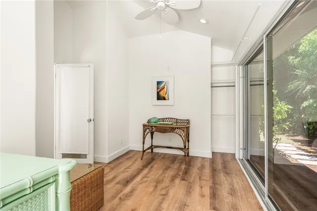 a bedroom with a bed and a dresser next to a window