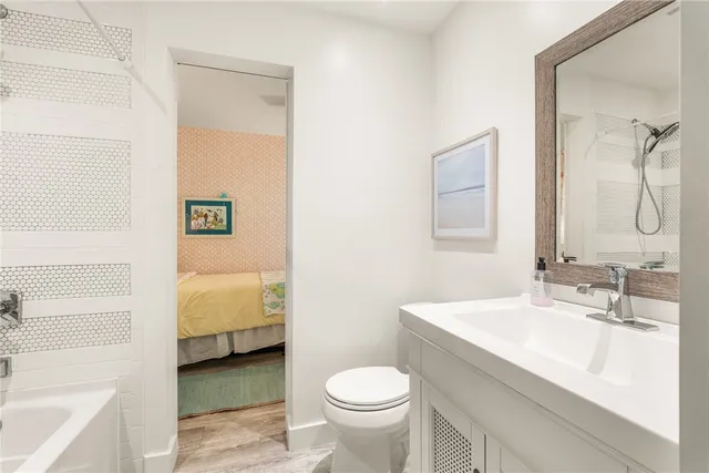 a bathroom with a sink a toilet and a mirror