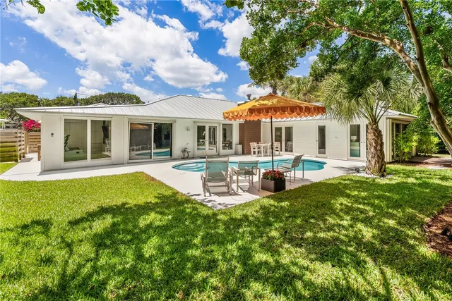 a view of a house with a yard patio and fire pit