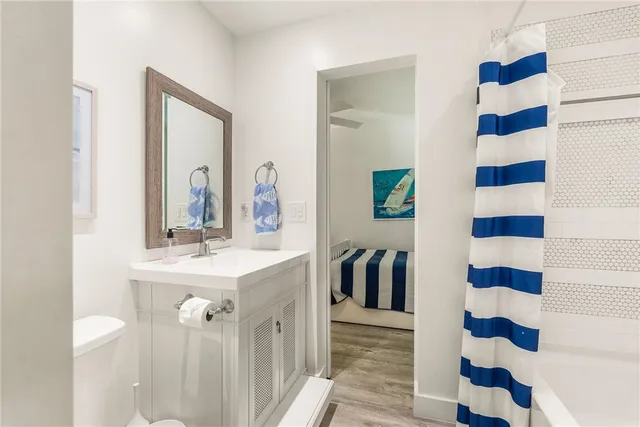 a view of a bathroom with a sink and mirror