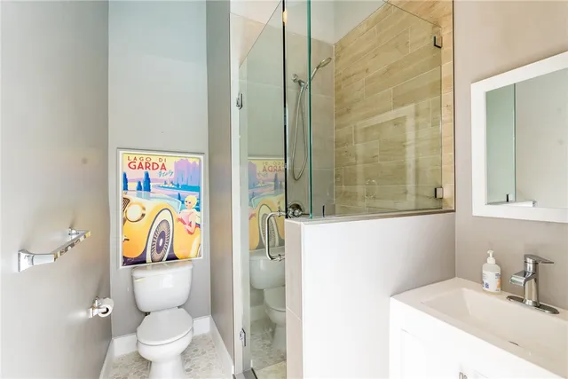 a bathroom with a toilet sink vanity and mirror