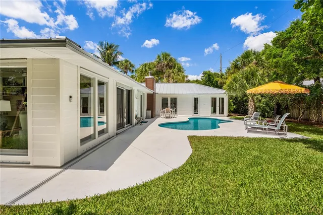 a view of a house with backyard porch and sitting area