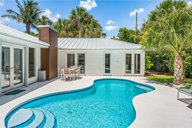 a view of a patio with swimming pool table and chairs