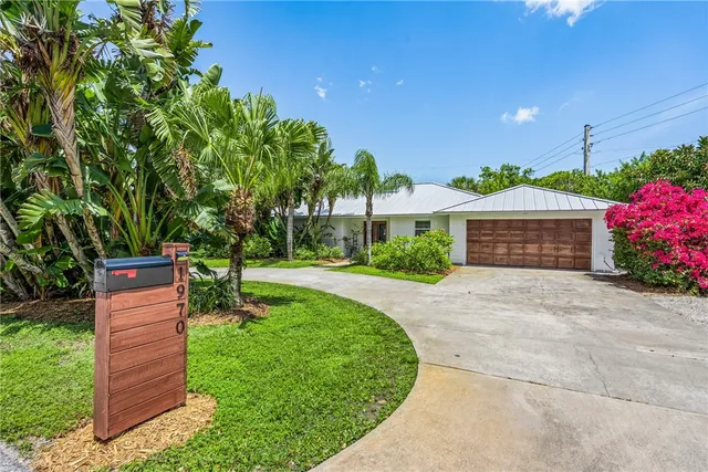 a front view of a house with a yard and a garage