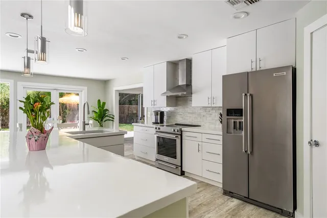 a kitchen with stainless steel appliances a refrigerator sink and stove