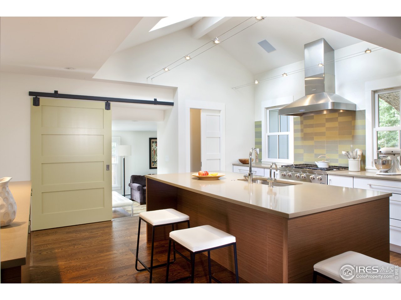 3221 8th Street Boulder, CO 80304 - Photo 9 of 39 Barn doors to family room, kitchen island
