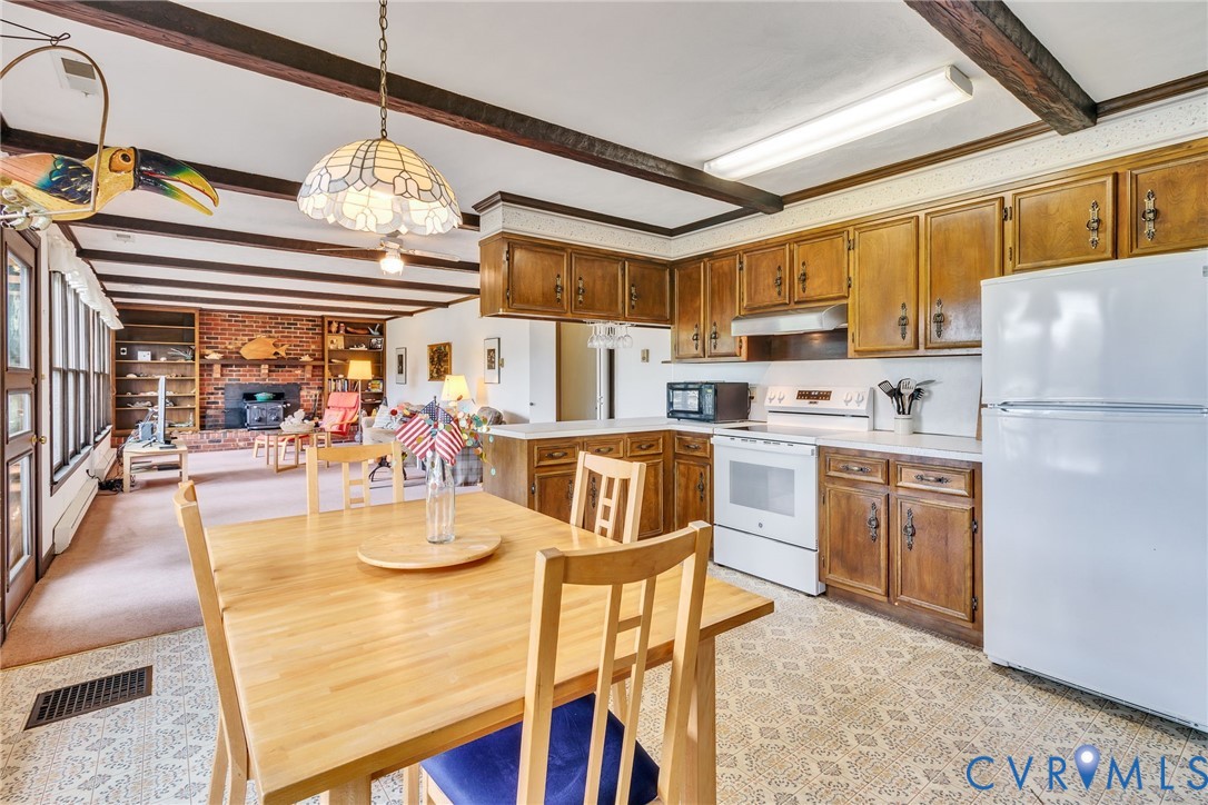 142 Bridge Lane Reedville, VA 22539 - Photo 3 of 56 a kitchen with refrigerator cabinets and dining table