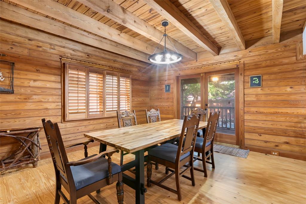 809 Cardinal Avenue Palm Harbor, FL 34683 - Photo 13 of 66 a view of a dining room with furniture and wooden floor