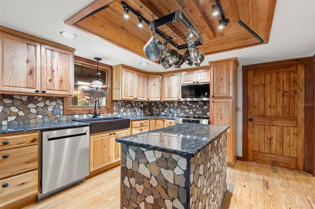 809 Cardinal Avenue Palm Harbor, FL 34683 - Photo 15 of 66 a kitchen with stainless steel appliances granite countertop a sink and cabinets