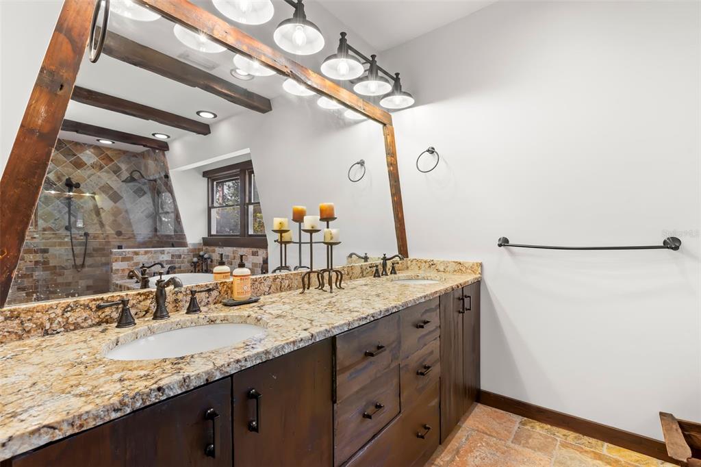 809 Cardinal Avenue Palm Harbor, FL 34683 - Photo 28 of 66 a bathroom with a granite countertop sink and a mirror