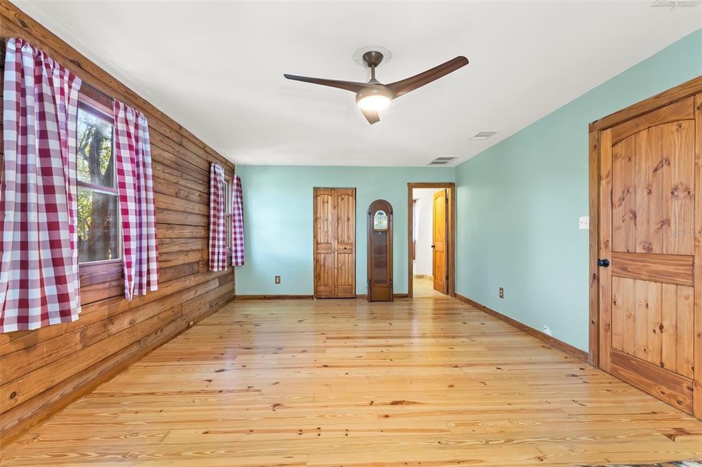 809 Cardinal Avenue Palm Harbor, FL 34683 - Photo 32 of 66 a view of an empty room with wooden floor and a window