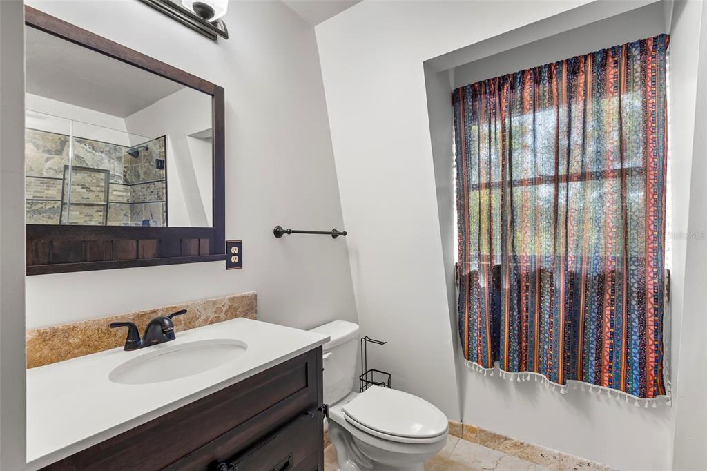 809 Cardinal Avenue Palm Harbor, FL 34683 - Photo 34 of 66 a bathroom with a sink toilet and shower