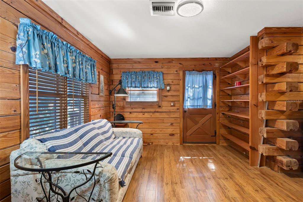 809 Cardinal Avenue Palm Harbor, FL 34683 - Photo 40 of 66 a backyard of a house with wooden floor chairs and wooden floor