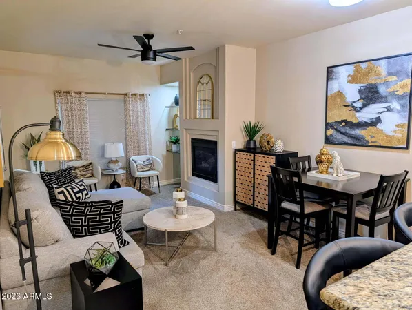a view of a livingroom and dining room with furniture wooden floor a chandelier